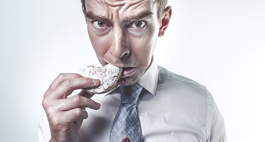 a man eating a brownie